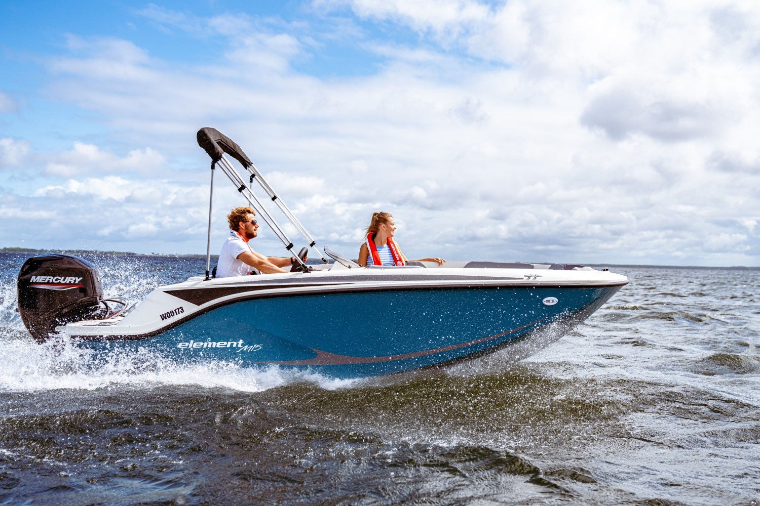 couple riding in a blue M15 deck boat