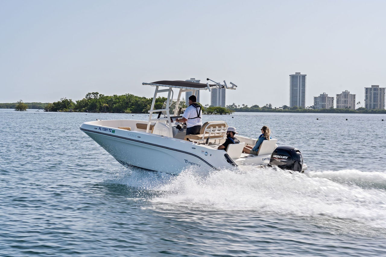 A Trophy 22CC on the lake in front of tall buildings