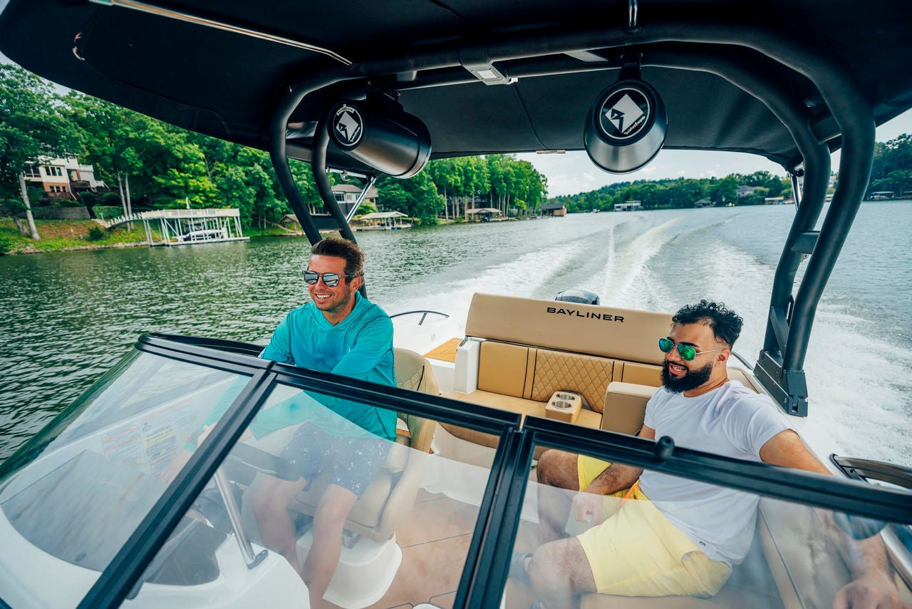 two men in the interior of a D20 deck boat