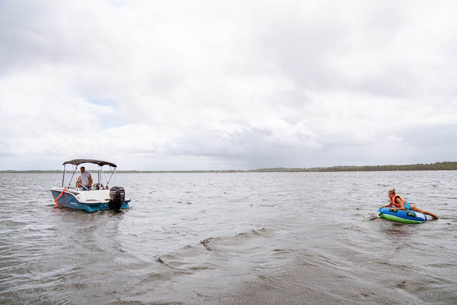 woman tubing behind an Element M15 deck boat