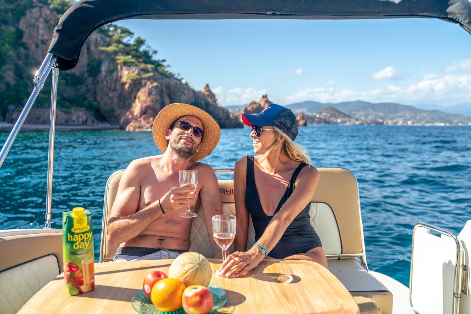 couple sitting at the table on the deck of the Ciera 8 overnight boat