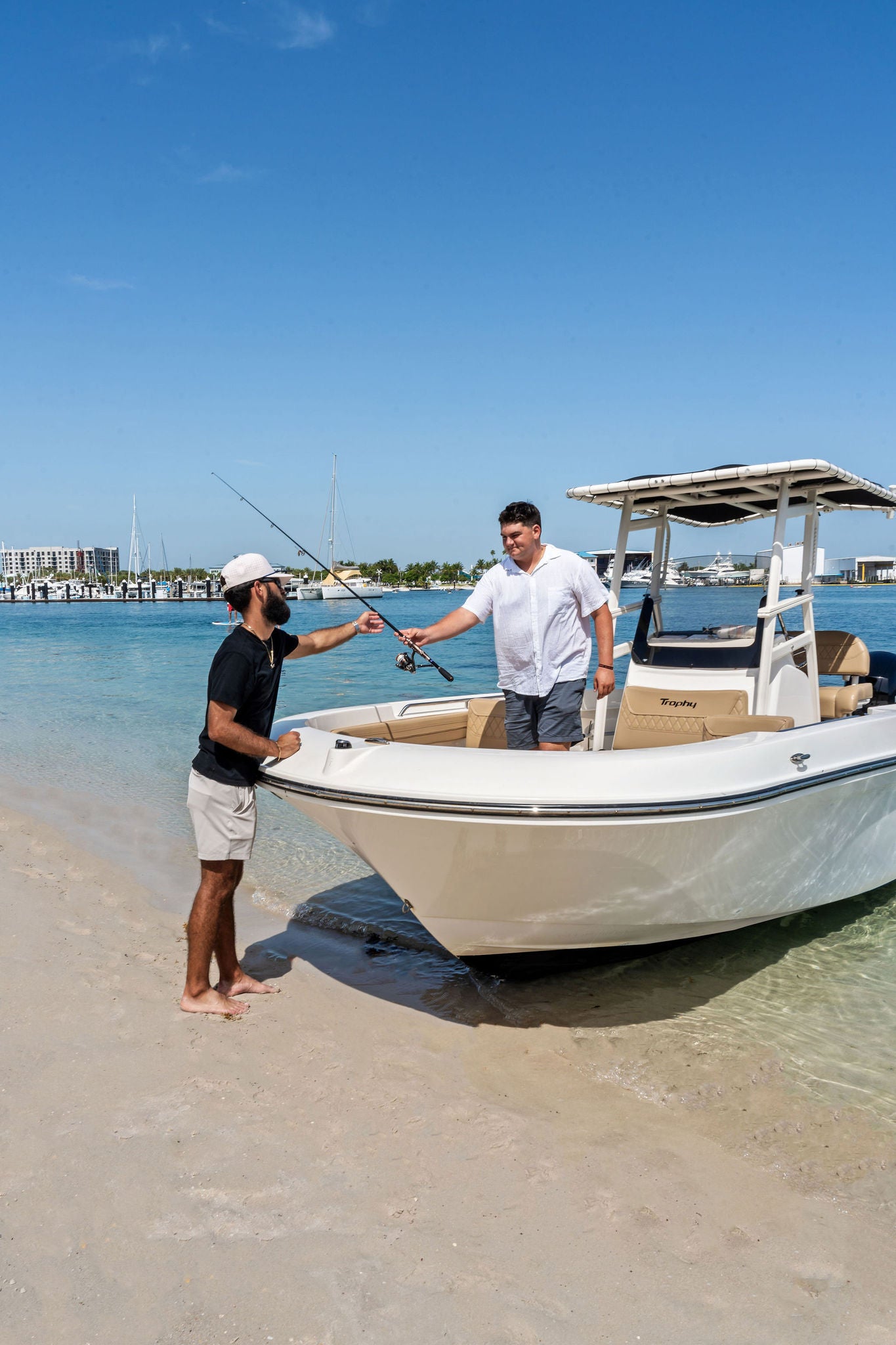 Two friends loading a beached T22CC for a day of fishing