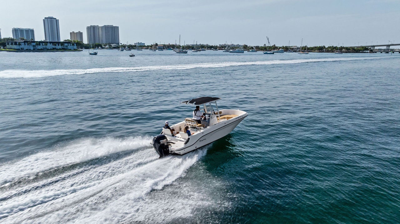 A Trophy 22CC on the water in front of tall buildings