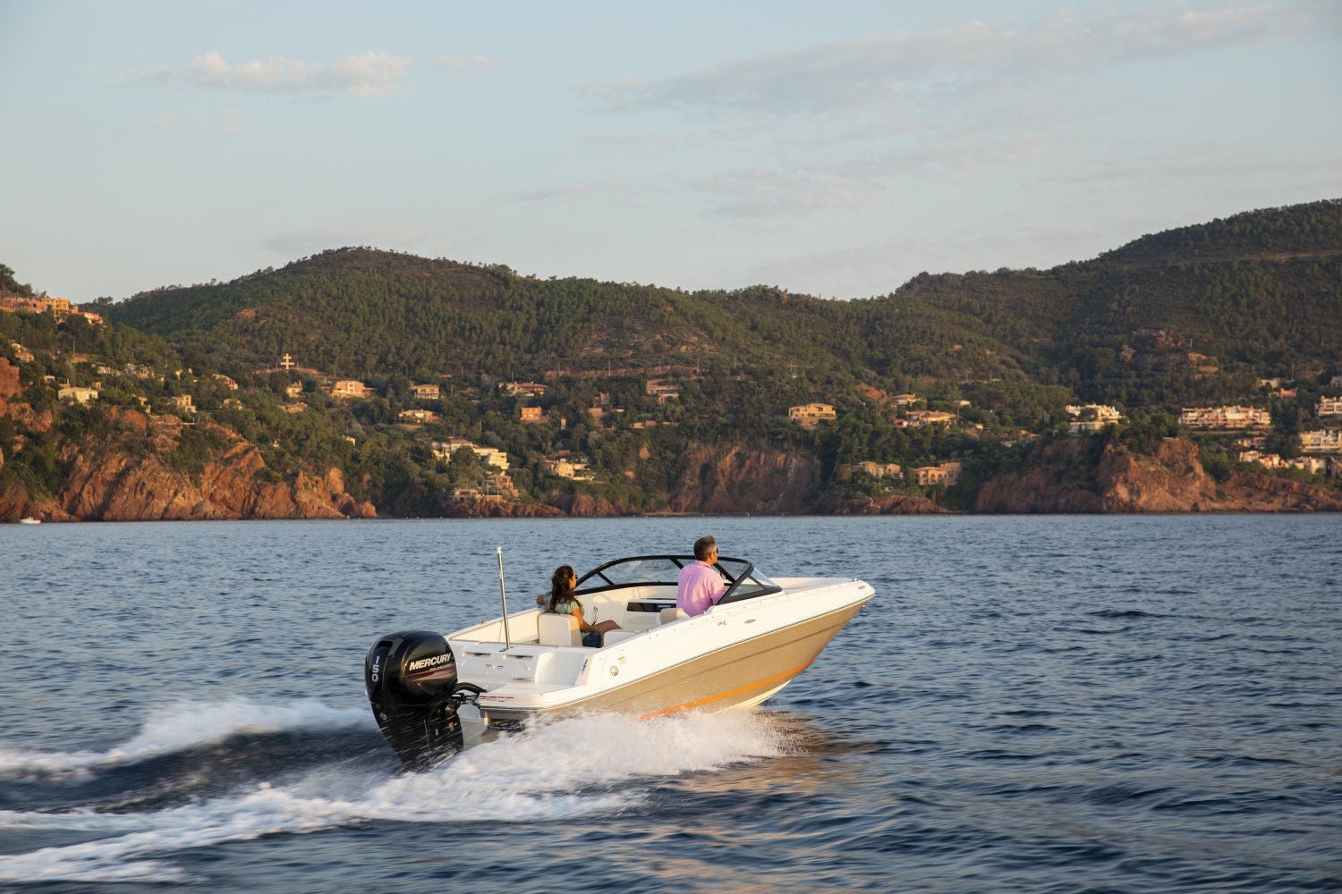 couple riding on a white VR4 outboard bowrider boat