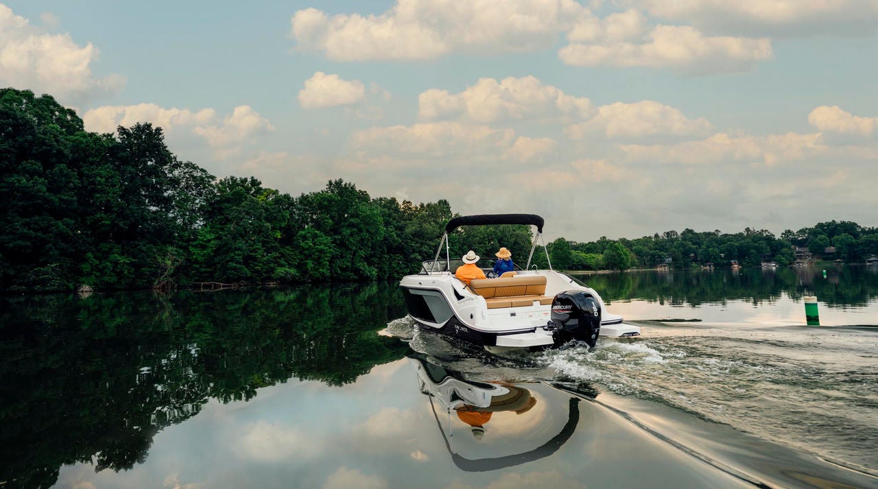 rear view of a D22 deck boat cruising on a lake