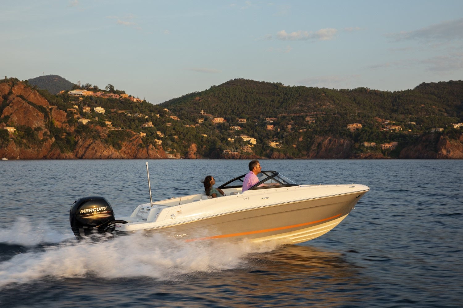 couple riding on a white VR4 outboard bowrider boat