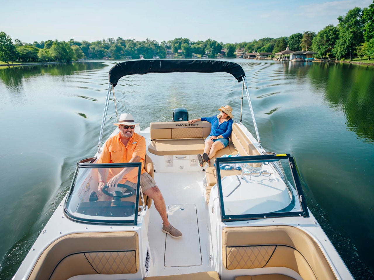 couple riding on a D22 deck boat