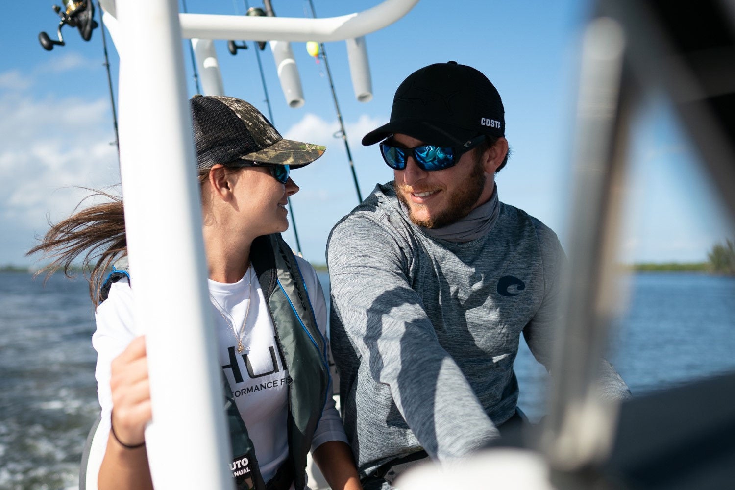 a couple riding on the Trophy T24CC fishing boat