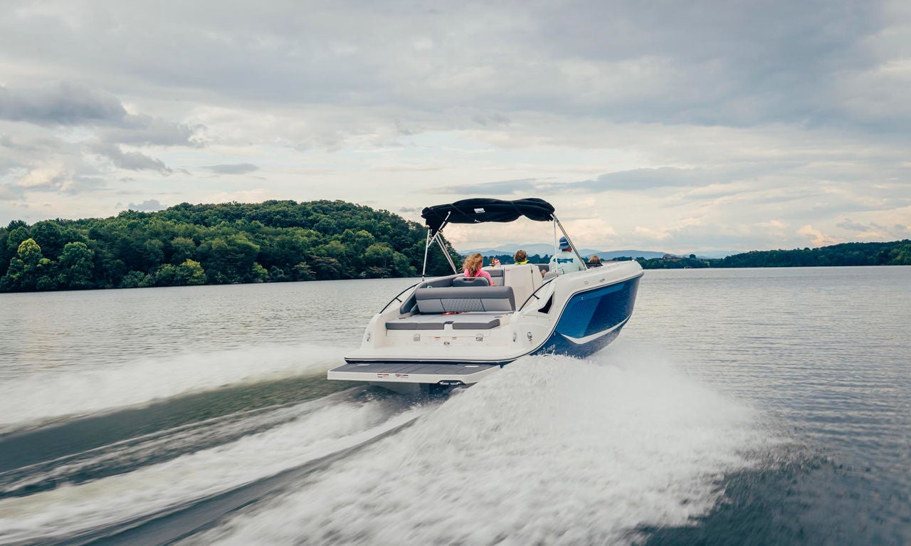 rear view of a blue D22i deck boat running