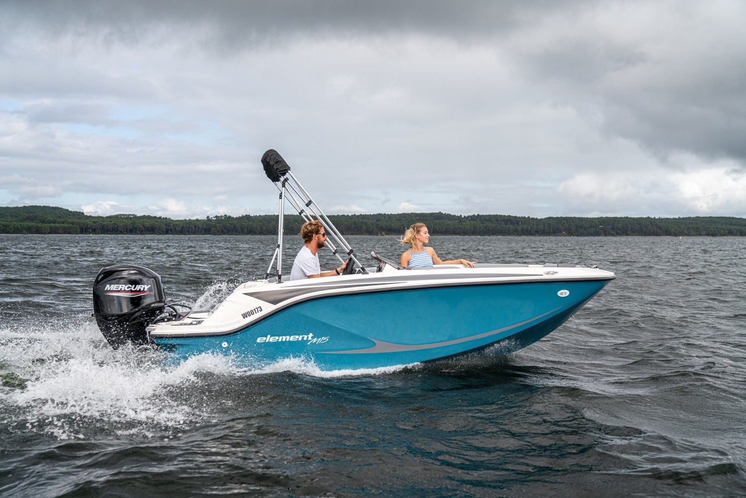 couple riding in a blue M15 deck boat running