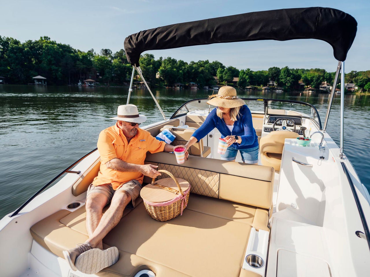 couple lounging on the back of the D22 deck boat