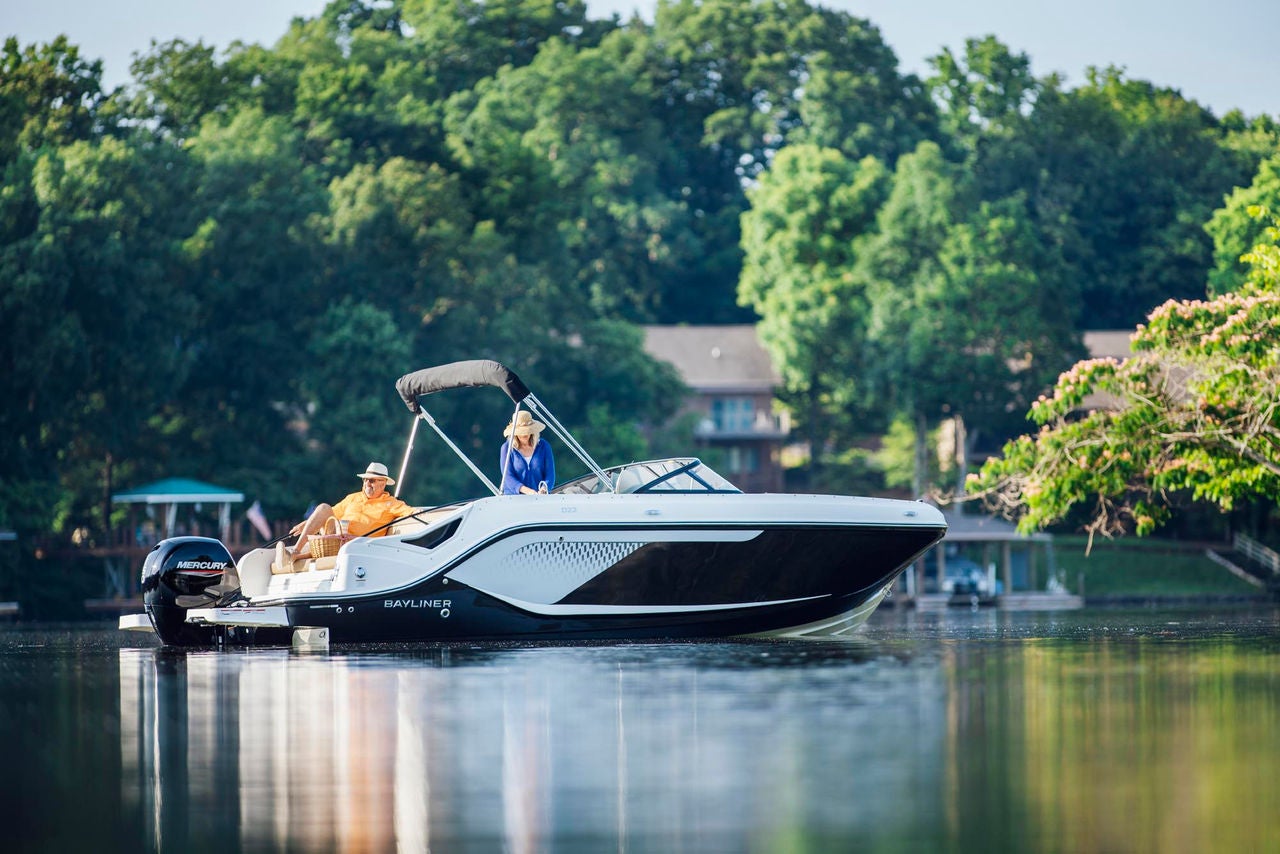 a couple lounging on a floating D22 deck boat