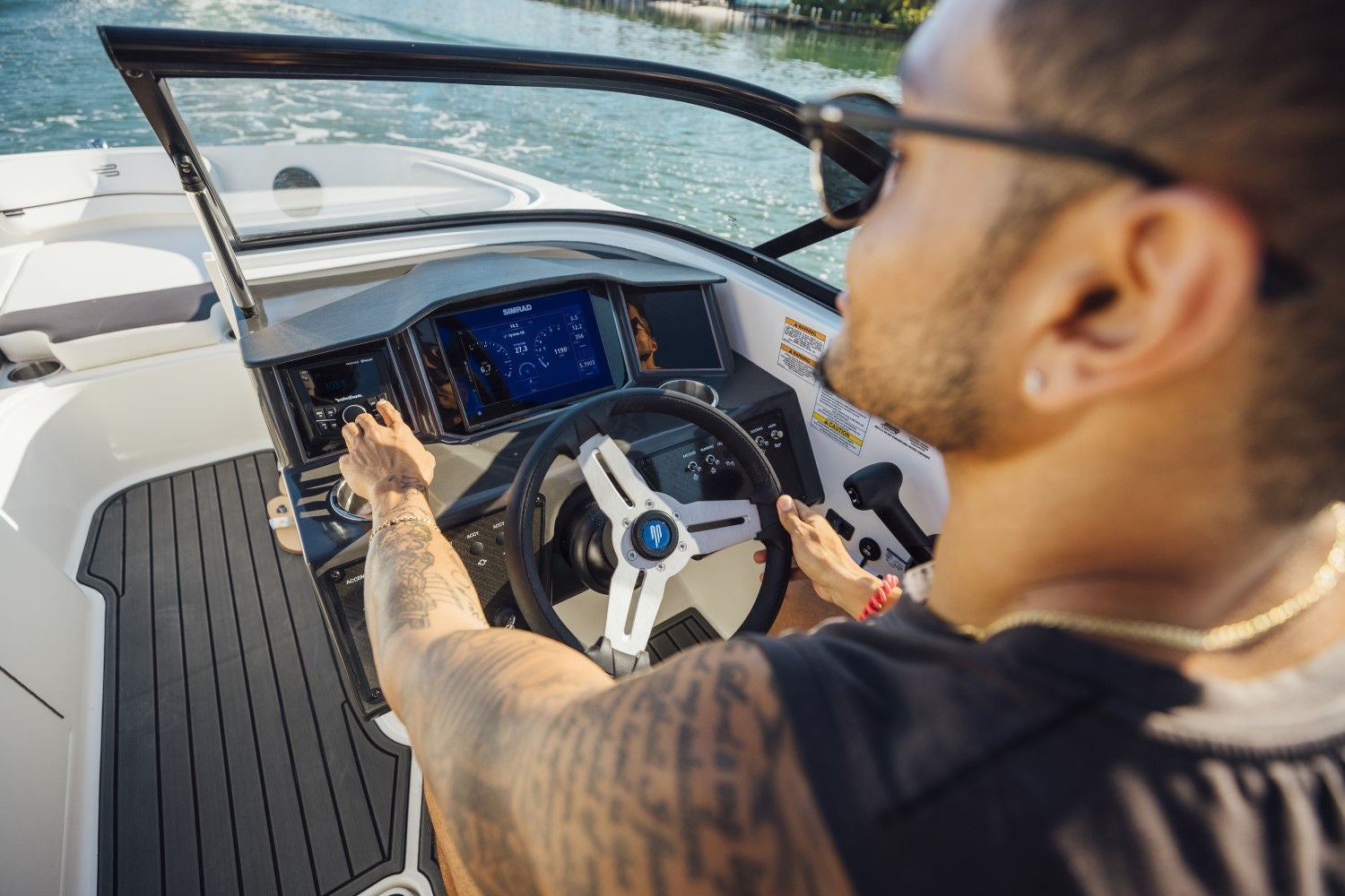 man at the helm of a VR6 Outboard bowrider boat