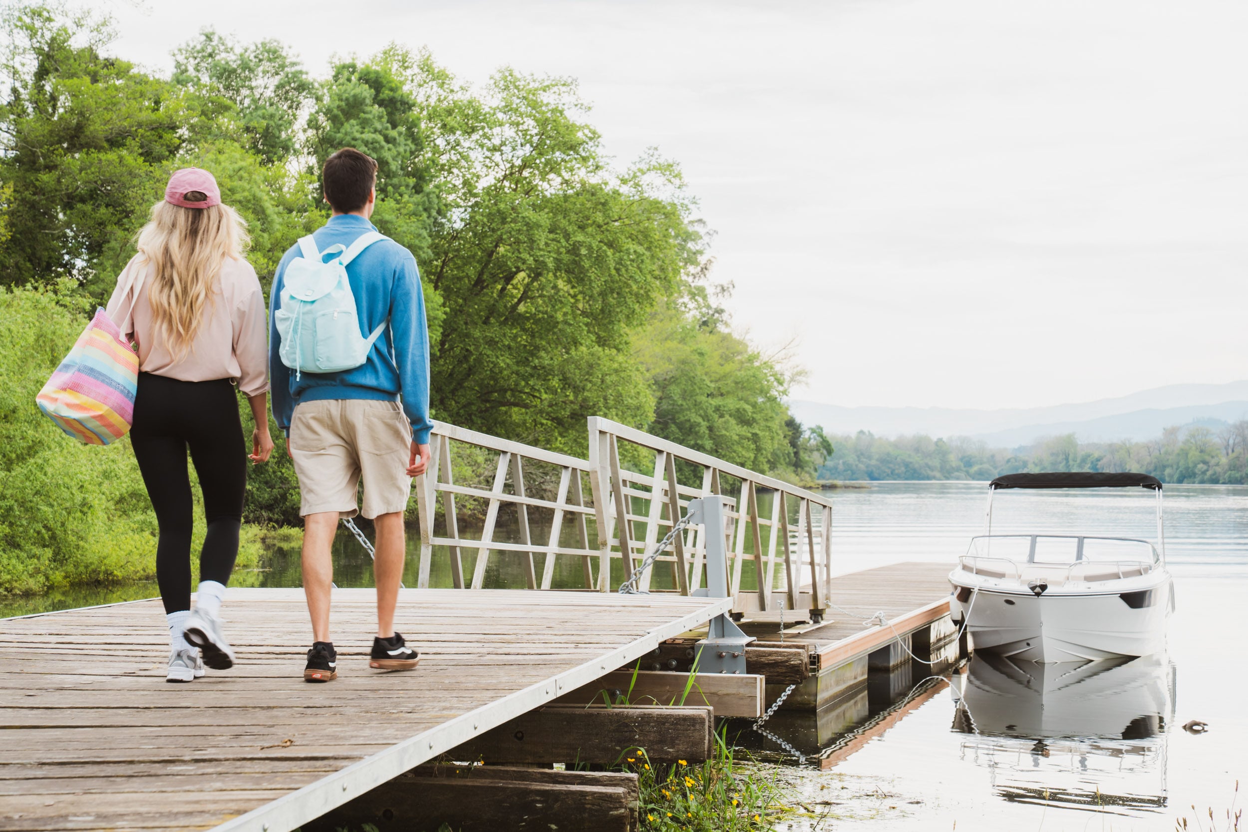 people walk on dock toward Bayliner C21
