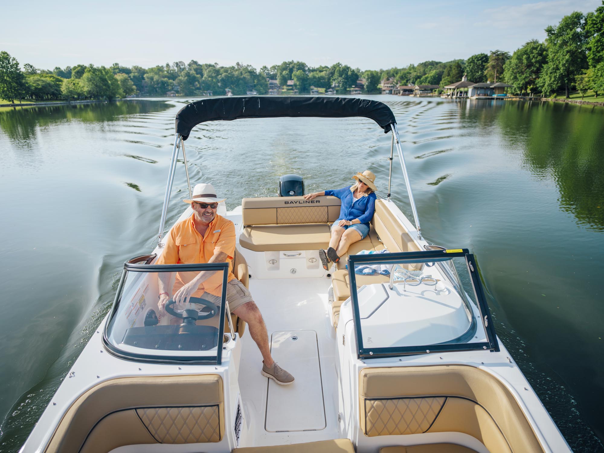 couple riding on a D22 deck boat