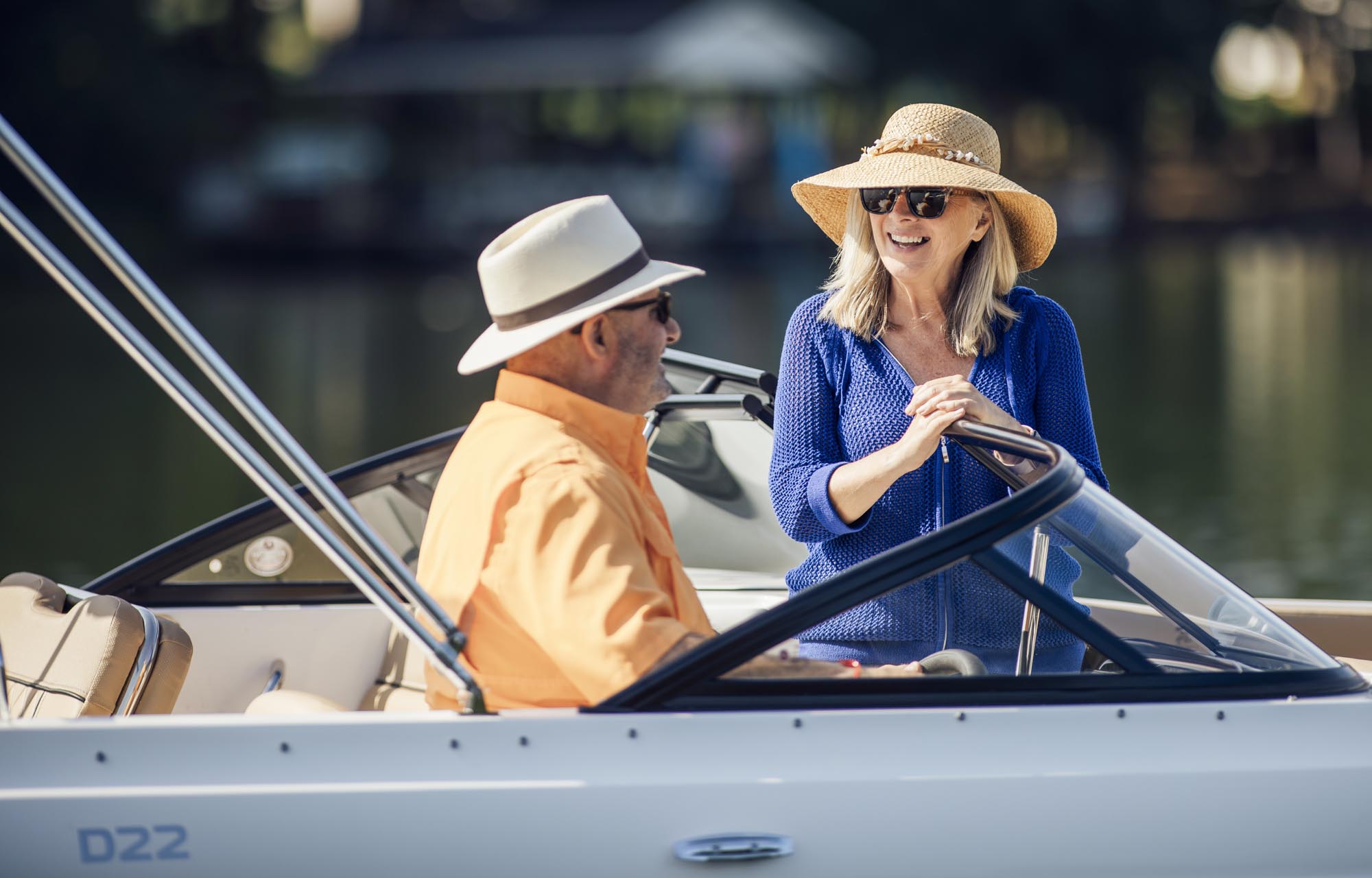 couple chatting on a D22 deck boat