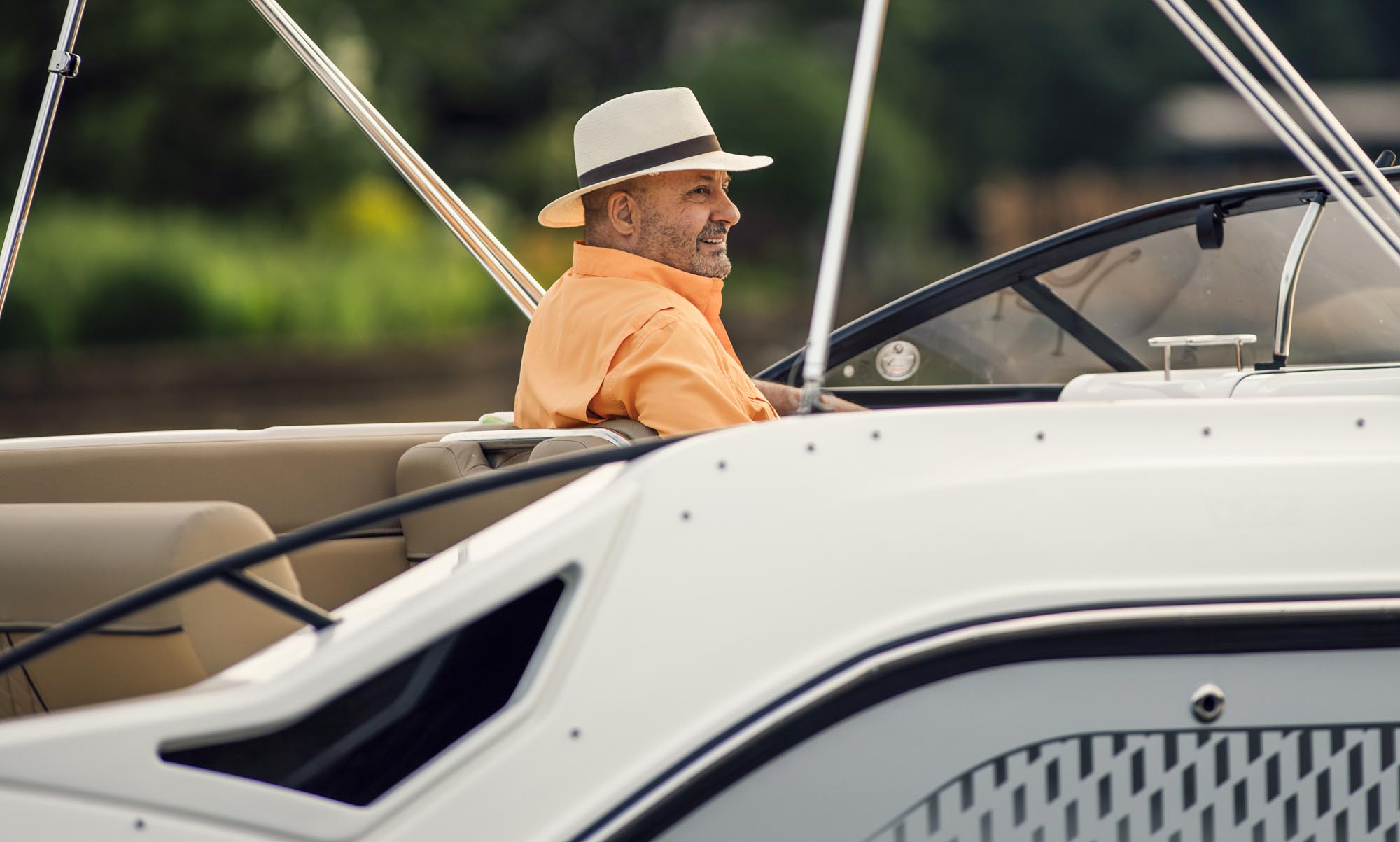 man sitting at the helm of the D22 deck boat
