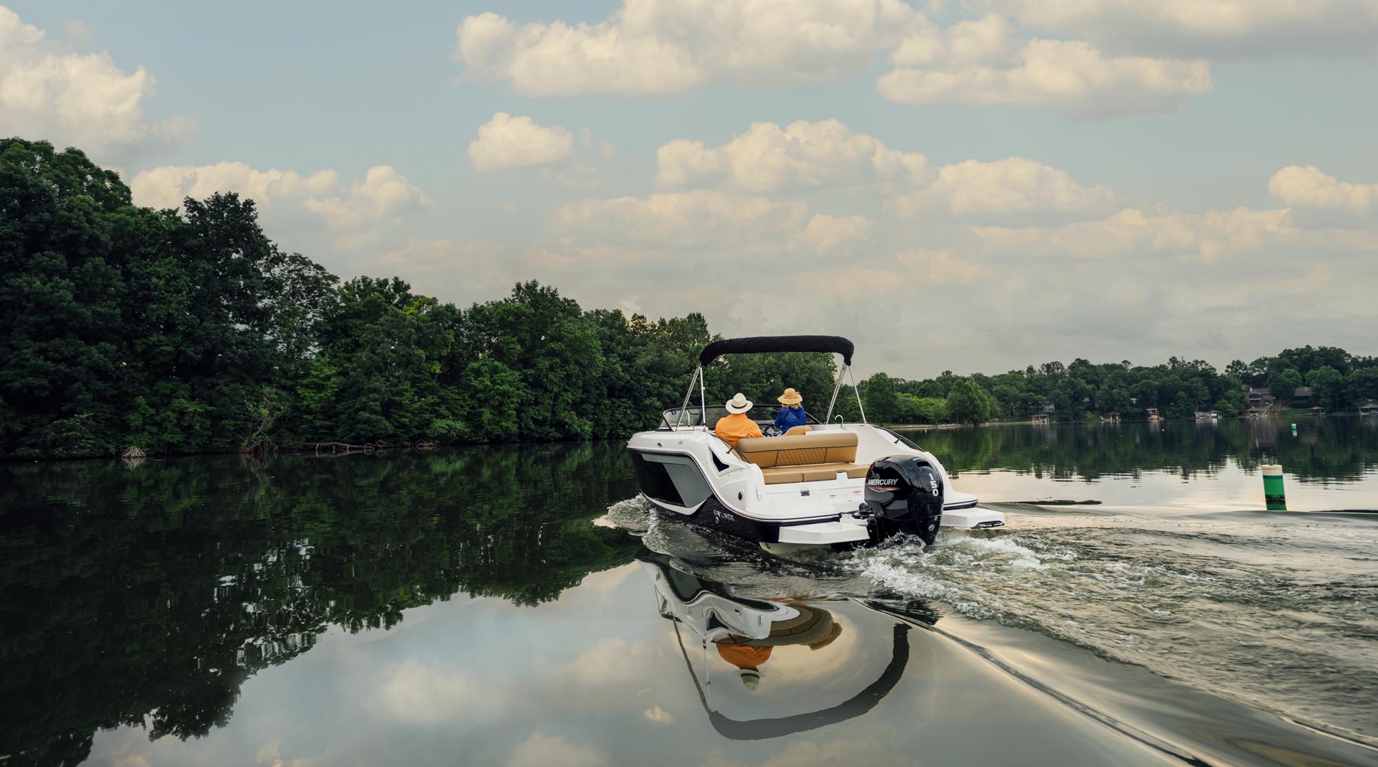rear view of a D22 deck boat cruising on a lake
