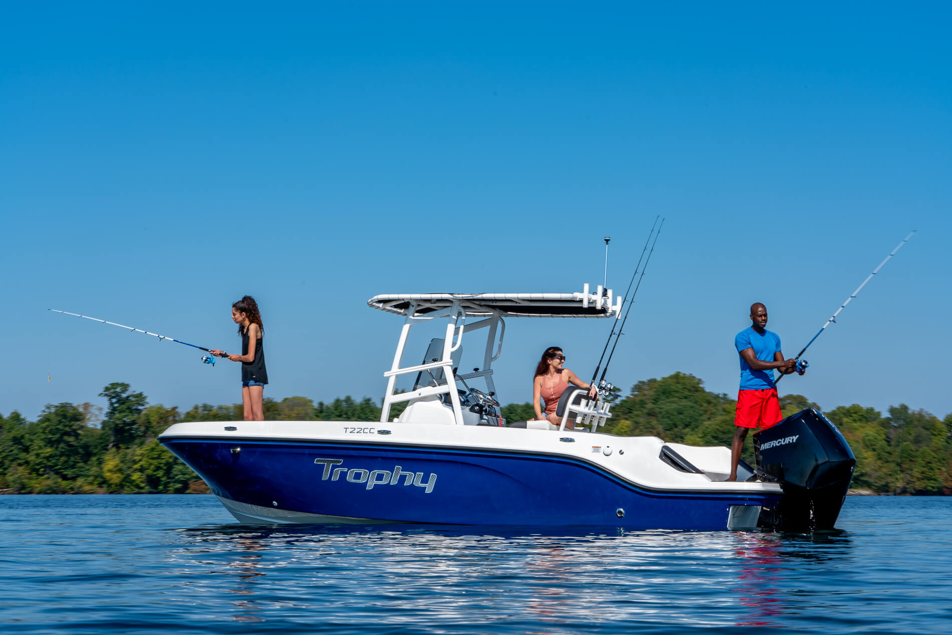family lounging on the front of a Trophy T22CC fishing boat