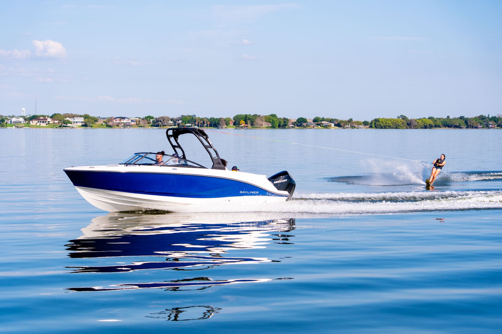blue V22 bowrider towing a person in a tube