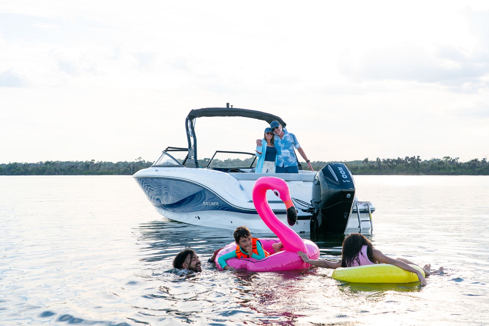 family in the water behind a V22 bowrider